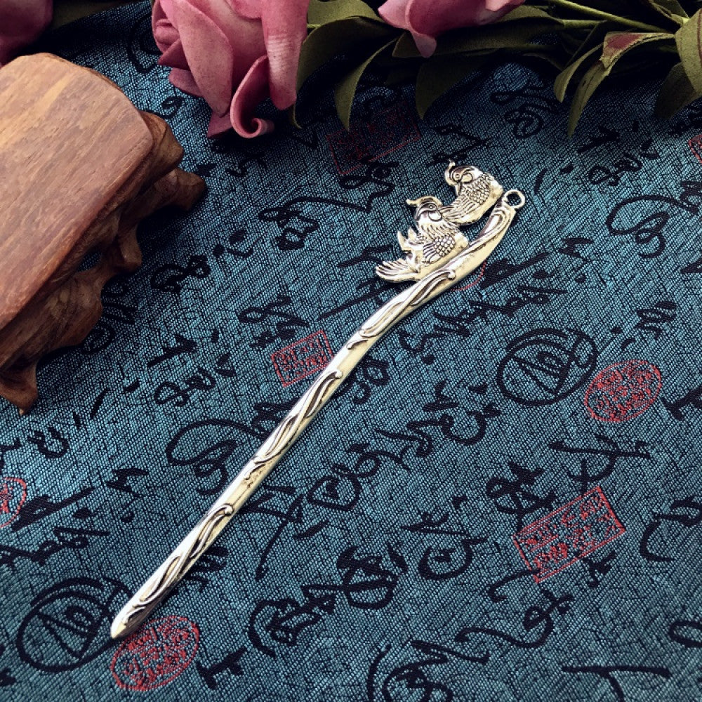 Boho vintage ethnic silver-tone hair stick featuring an intricate curved decorative top, displayed on a blue fabric with text patterns 06