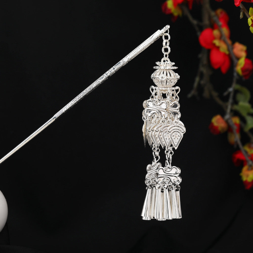 Boho vintage ethnic silver-tone hair stick featuring an intricate rooster-shaped charm, detailed decorative accents, and layered silver tassel pendants, displayed against a black background with red floral decor, ideal for bohemian and traditional fashion enthusiasts in the US