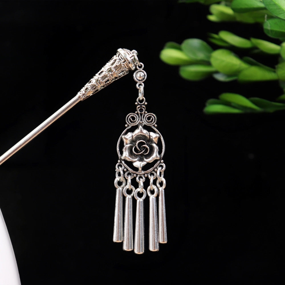 Boho vintage ethnic silver-tone hair stick featuring turquoise beads, an intricate round decorative element, and layered chain tassel fringe, displayed beside a white vessel green foliage , ideal for bohemian and traditional fashion enthusiasts in the US 03