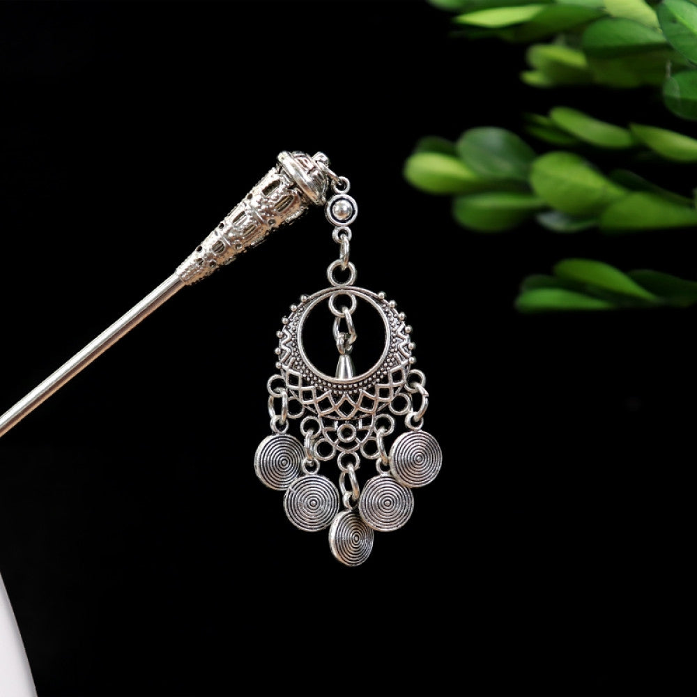 Boho vintage ethnic silver-tone hair stick featuring turquoise beads, an intricate round decorative element, and layered chain tassel fringe, displayed beside a white vessel green foliage , ideal for bohemian and traditional fashion enthusiasts in the US 05
