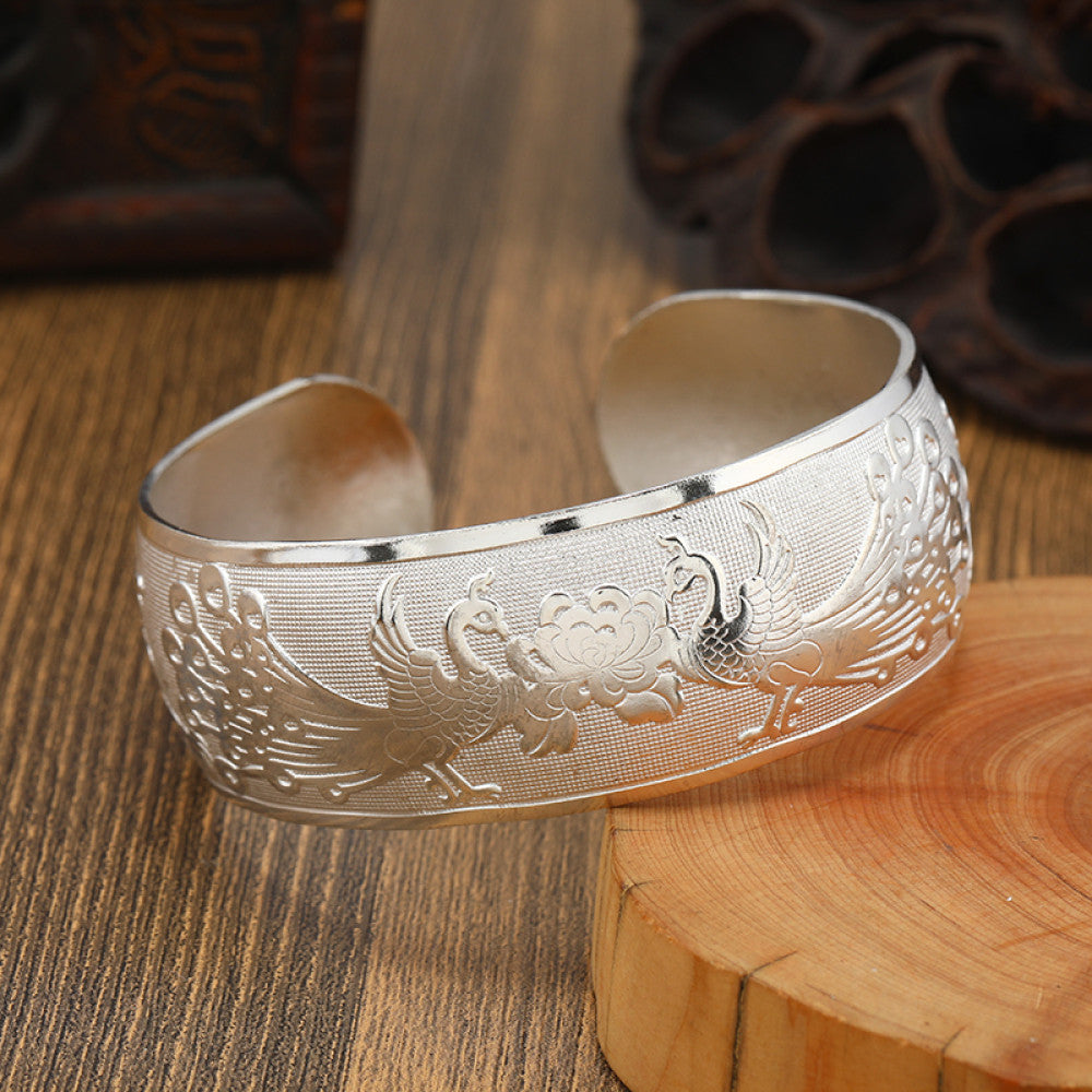 Boho vintage ethnic silver cuff bangle with tribal geometric engravings, styled on wooden surface, perfect for bohemian and tribal fashion lovers in the US 02