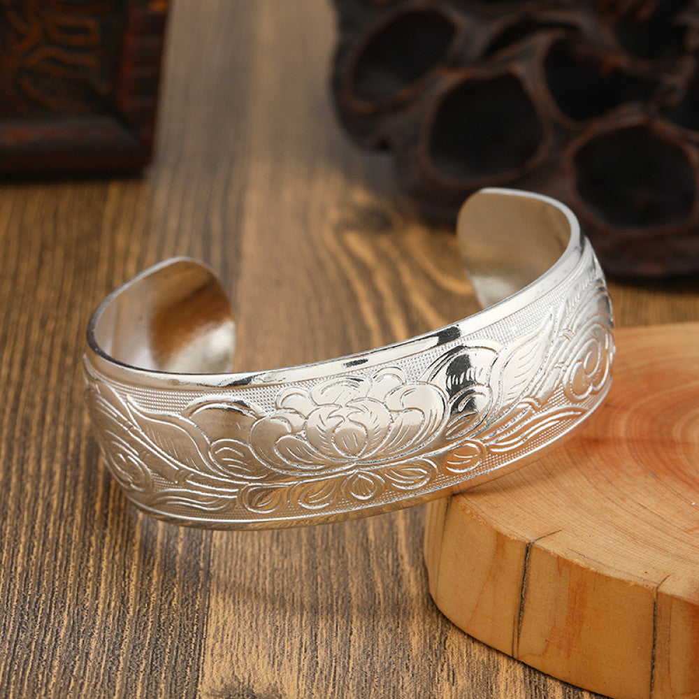 Boho vintage ethnic silver cuff bangle with tribal geometric engravings, styled on wooden surface, perfect for bohemian and tribal fashion lovers in the US 11