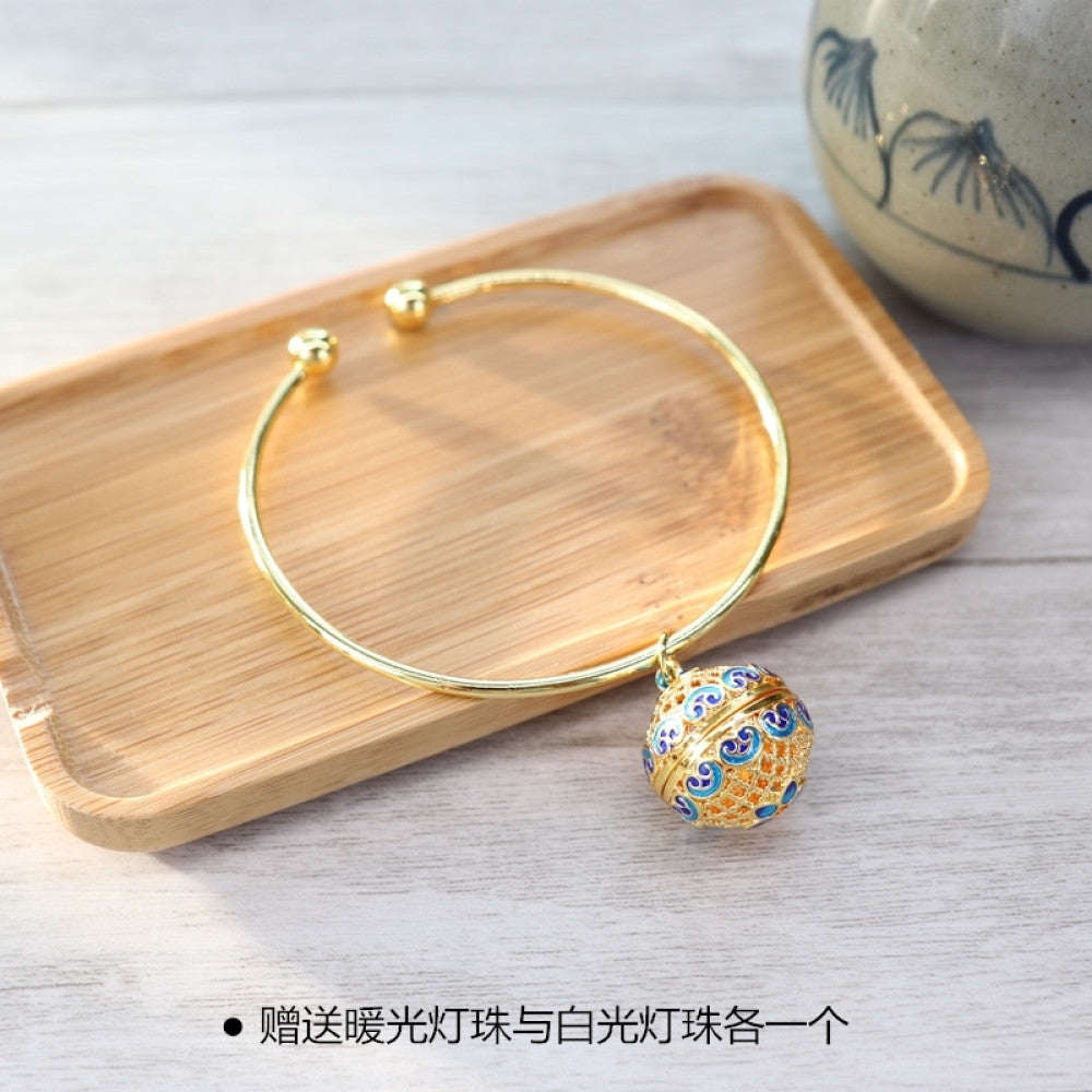 Boho vintage gold bangle with sakura locket charm, styled on wooden tray, ideal for bohemian and floral fashion enthusiasts 04