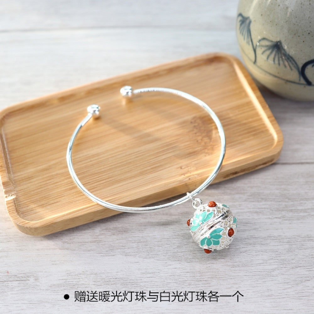 Boho vintage gold bangle with sakura locket charm, styled on wooden tray, ideal for bohemian and floral fashion enthusiasts 08