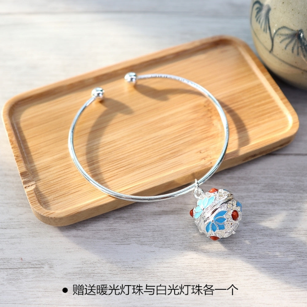 Boho vintage gold bangle with sakura locket charm, styled on wooden tray, ideal for bohemian and floral fashion enthusiasts 10