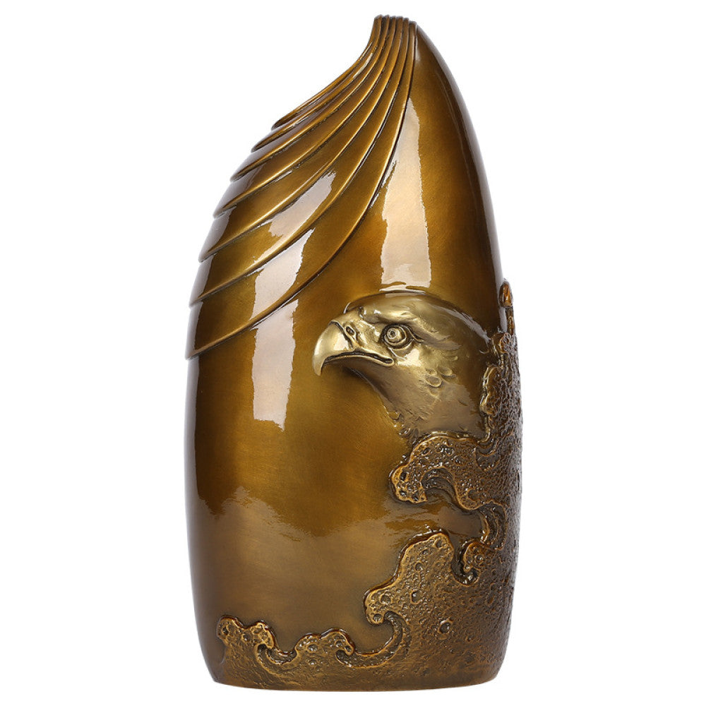 Brass eagle sculpture with textured details, placed on blue surface against dark gradient background 01