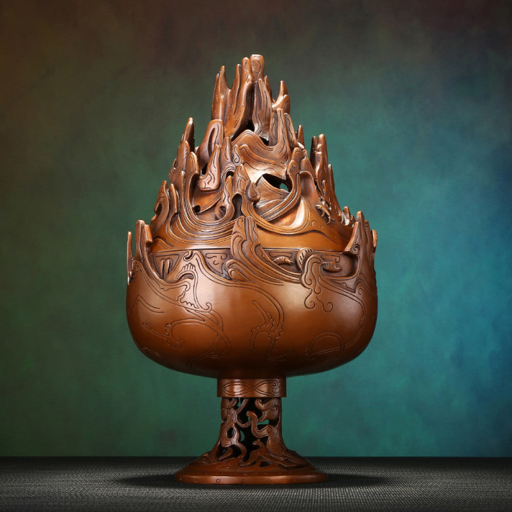 Intricate bronze Boshan-style Chinese incense burner with mountain-shaped pierced lid and dragon motifs, a Feng Shui symbol of wealth and elegance, displayed as a sophisticated home decor piece against a teal textured background