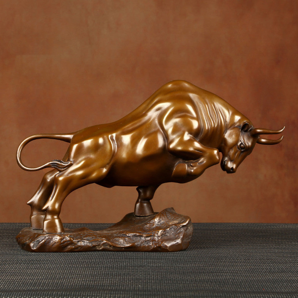Bronze bull statue with a powerful stance, a Feng Shui symbol of strength and good fortune, displayed as elegant home decor against a textured background