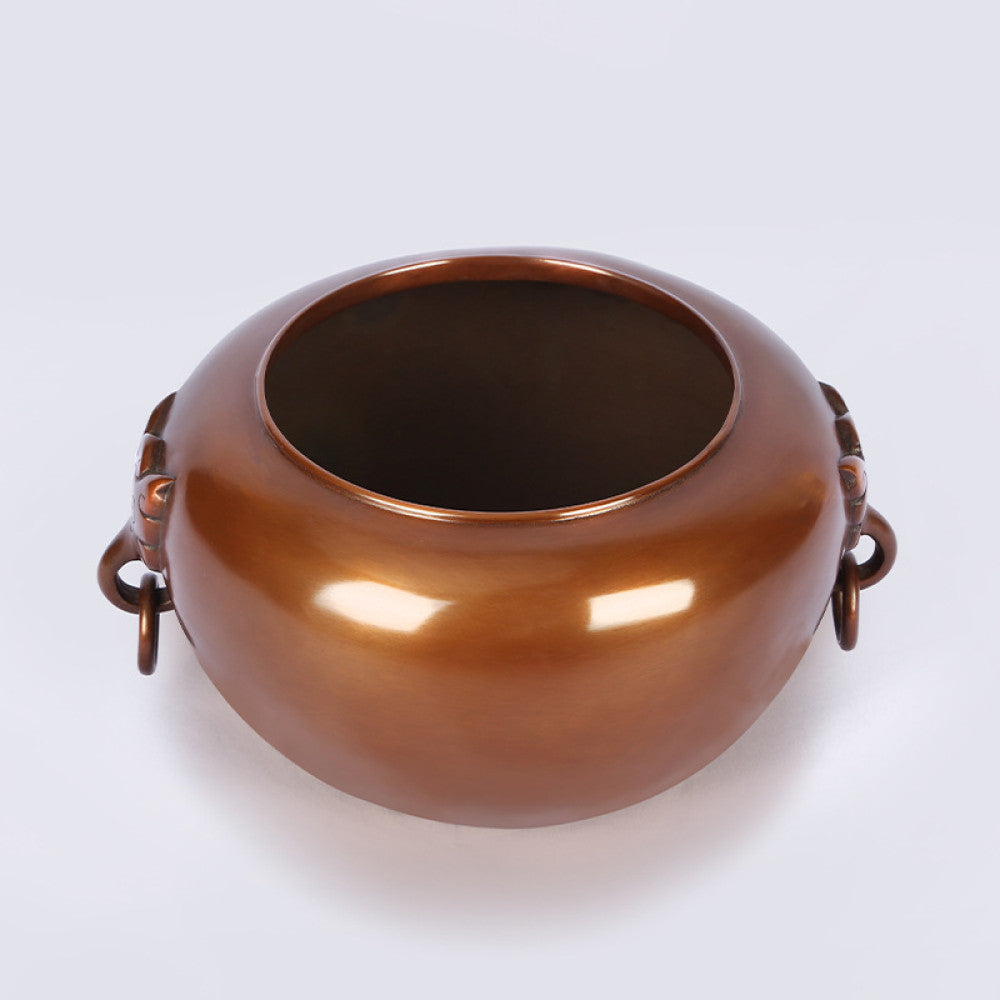Polished bronze Chinese censer with intricate beast-head handle and ring, a Feng Shui symbol of wealth and harmony, displayed as elegant home decor against a light background 02