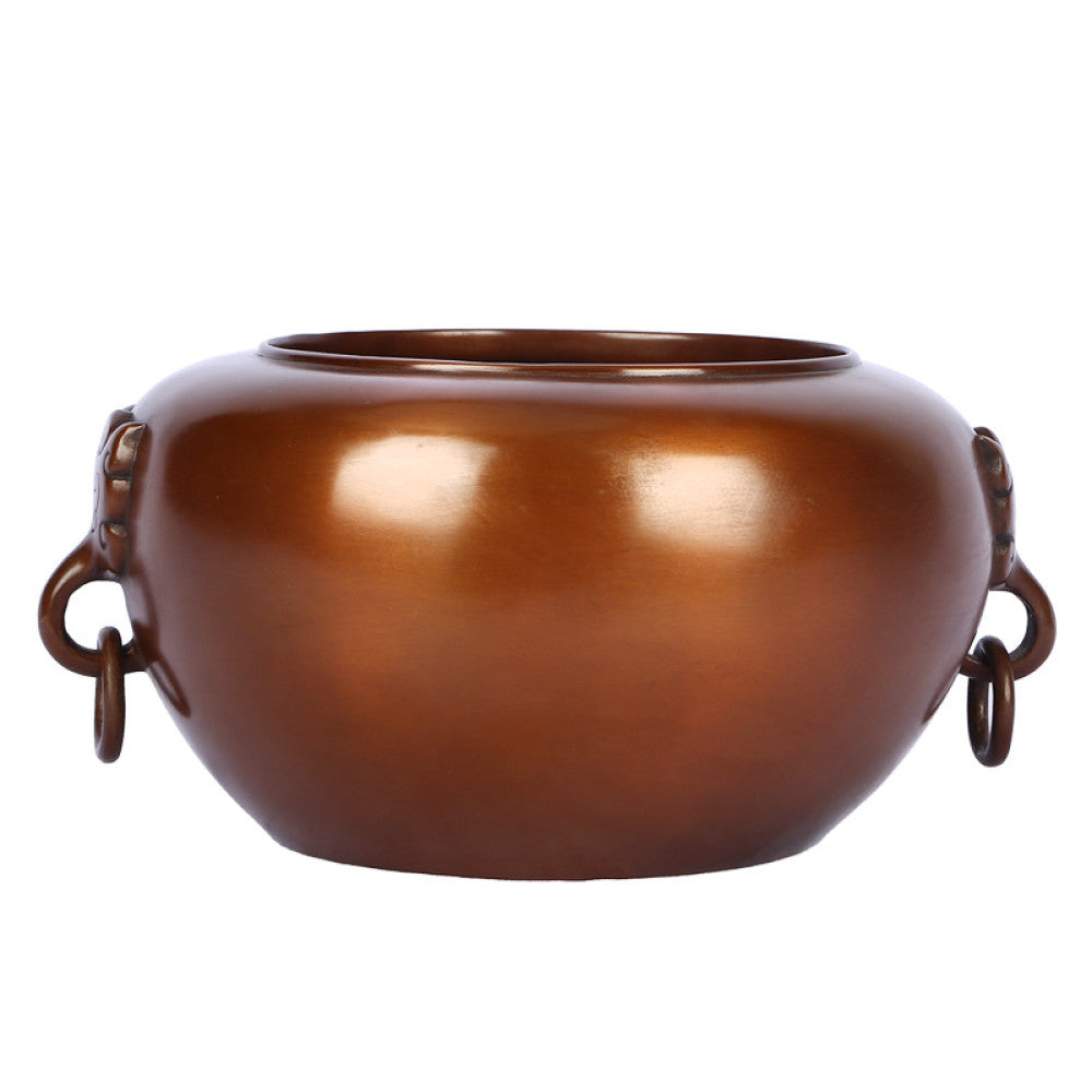 Polished bronze Chinese censer with intricate beast-head handle and ring, a Feng Shui symbol of wealth and harmony, displayed as elegant home decor against a light background 03