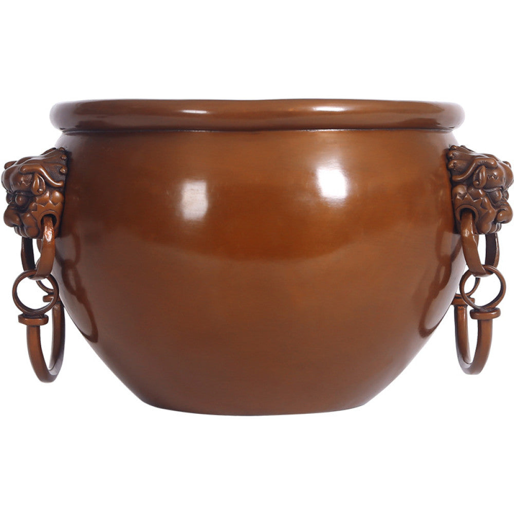 Polished bronze Chinese decorative vessel with intricate beast-head handles and hanging rings, a Feng Shui symbol of wealth and protection, displayed as elegant home decor against a white background