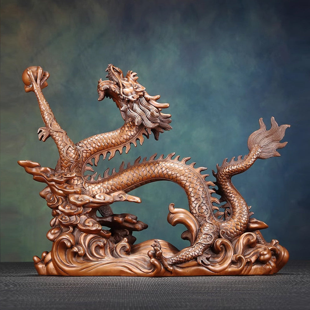 Intricate bronze Chinese dragon statue with detailed scales, a Feng Shui symbol of good fortune and strength, displayed as elegant home decor against a textured background