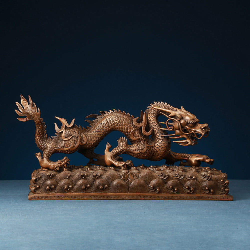 Intricate bronze Chinese dragon statue, a Feng Shui symbol of power and good fortune, displayed as elegant home decor against a dark blue background