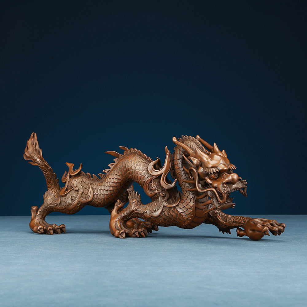 Intricate bronze Chinese dragon statue, a Feng Shui symbol of power and good fortune, displayed as elegant home decor against a dark blue background 01