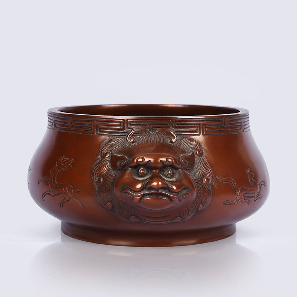 Intricate bronze Chinese incense burner with beast-head handles and traditional patterns, a Feng Shui symbol of wealth and harmony, displayed as elegant home decor against a white background 01