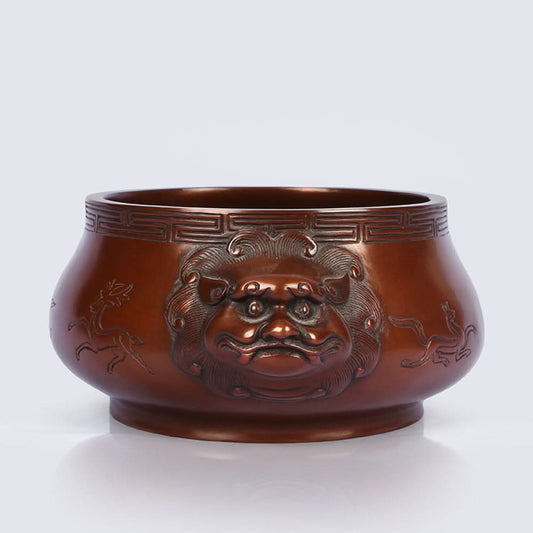 Intricate bronze Chinese incense burner with beast-head handles and traditional patterns, a Feng Shui symbol of wealth and harmony, displayed as elegant home decor against a white background 01