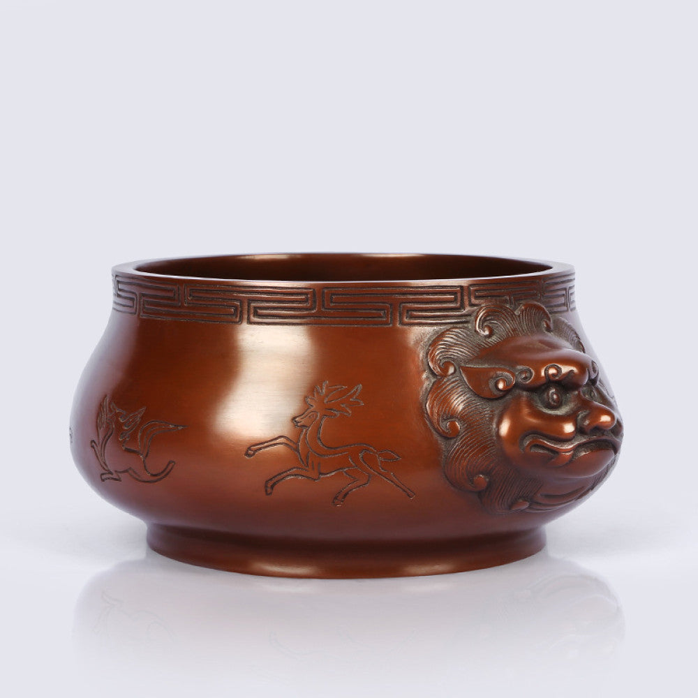 Intricate bronze Chinese incense burner with beast-head handles and traditional patterns, a Feng Shui symbol of wealth and harmony, displayed as elegant home decor against a white background 03