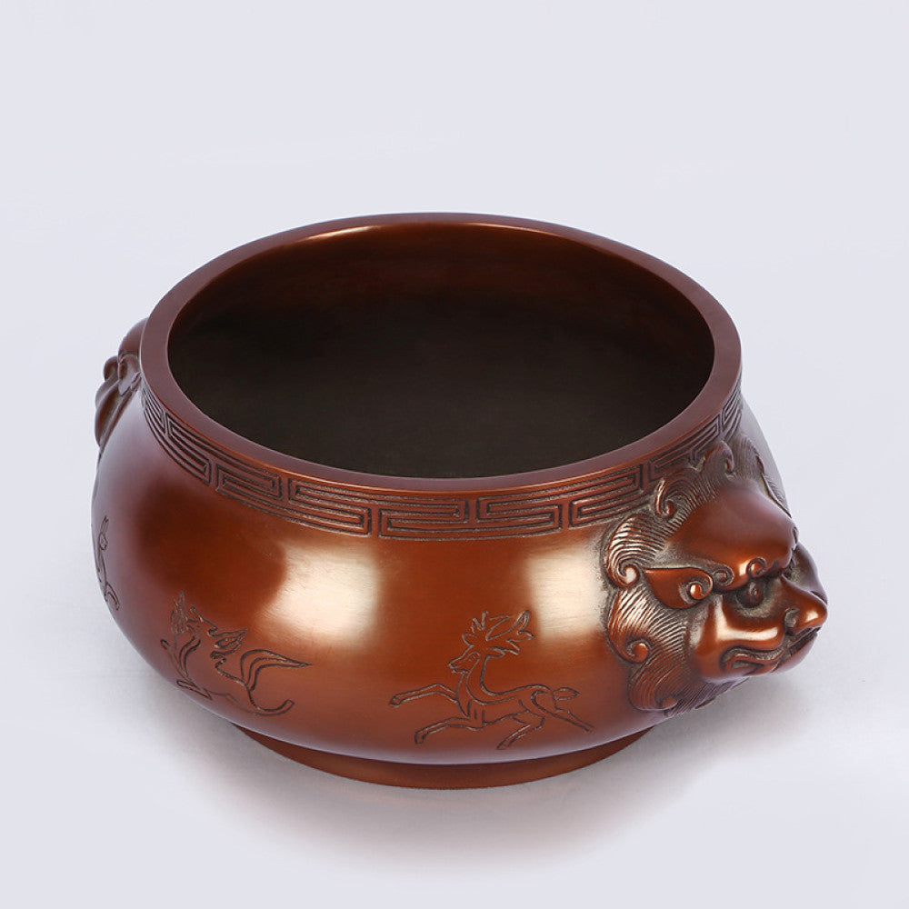Intricate bronze Chinese incense burner with beast-head handles and traditional patterns, a Feng Shui symbol of wealth and harmony, displayed as elegant home decor against a white background 04