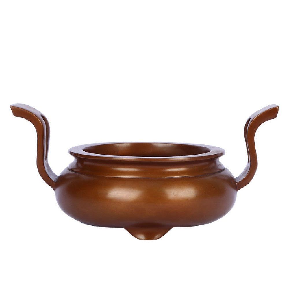 Polished bronze Chinese incense burner with elegant curved handles and three feet, a Feng Shui symbol of wealth and harmony, displayed as refined home decor against a white background