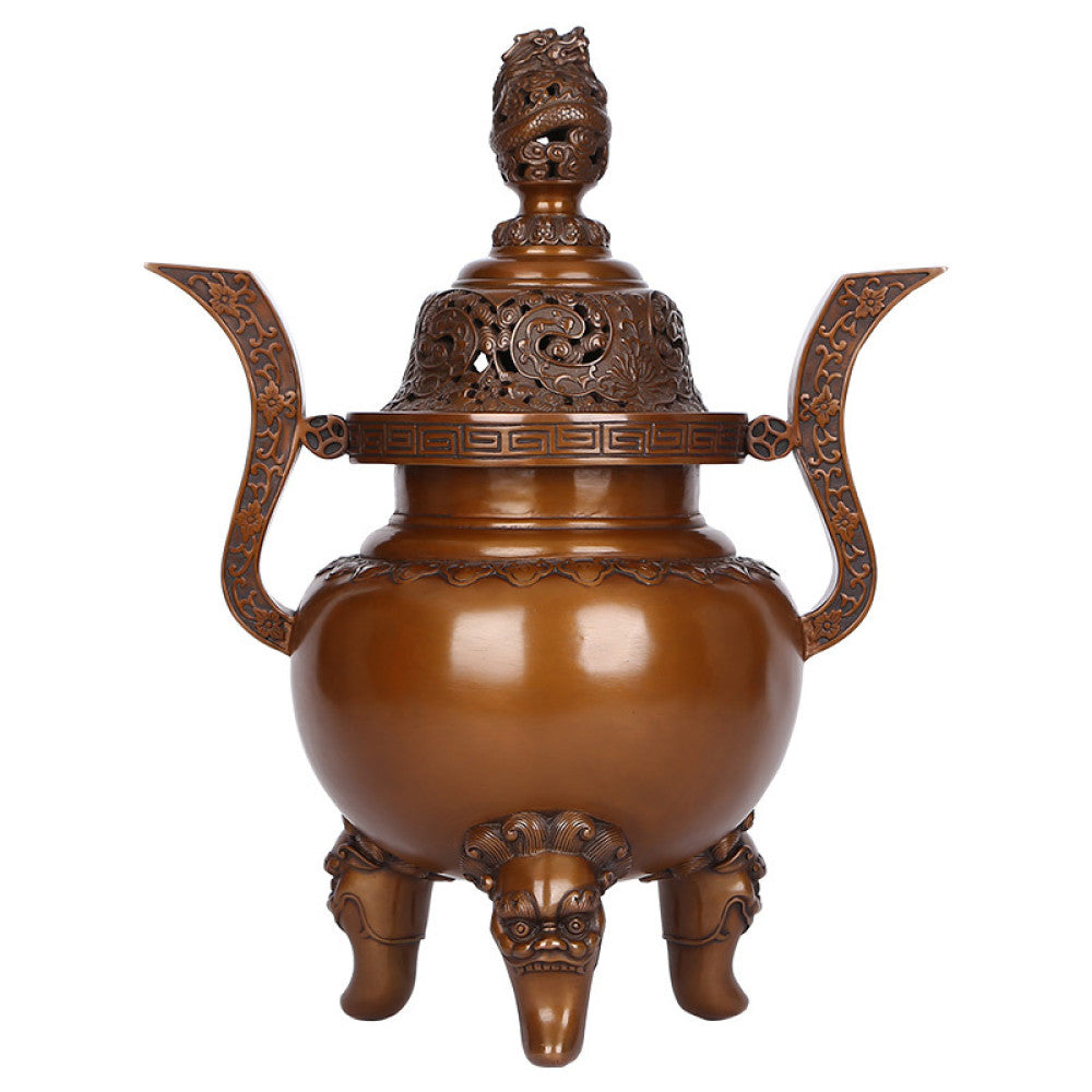Intricate bronze Chinese incense burner with dragon-topped pierced lid, ornate curved handles, and lion-shaped feet, a Feng Shui symbol of wealth and elegance, displayed as a sophisticated home decor piece against a teal textured background 06