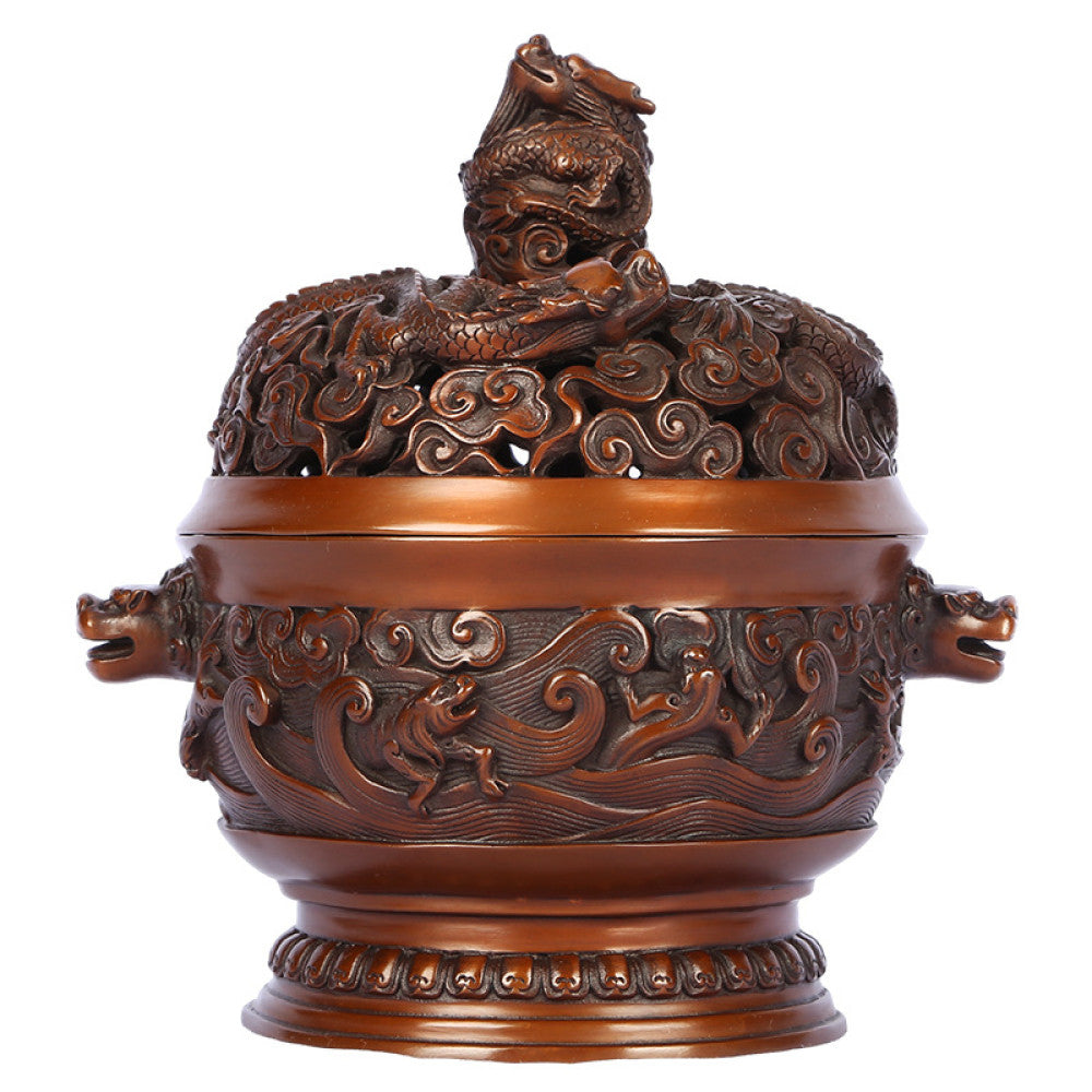 Intricate bronze Chinese incense burner with dragon-topped pierced lid, beast-head handles, and wave motifs, a Feng Shui symbol of wealth and protection, displayed as elegant home decor against a white background
