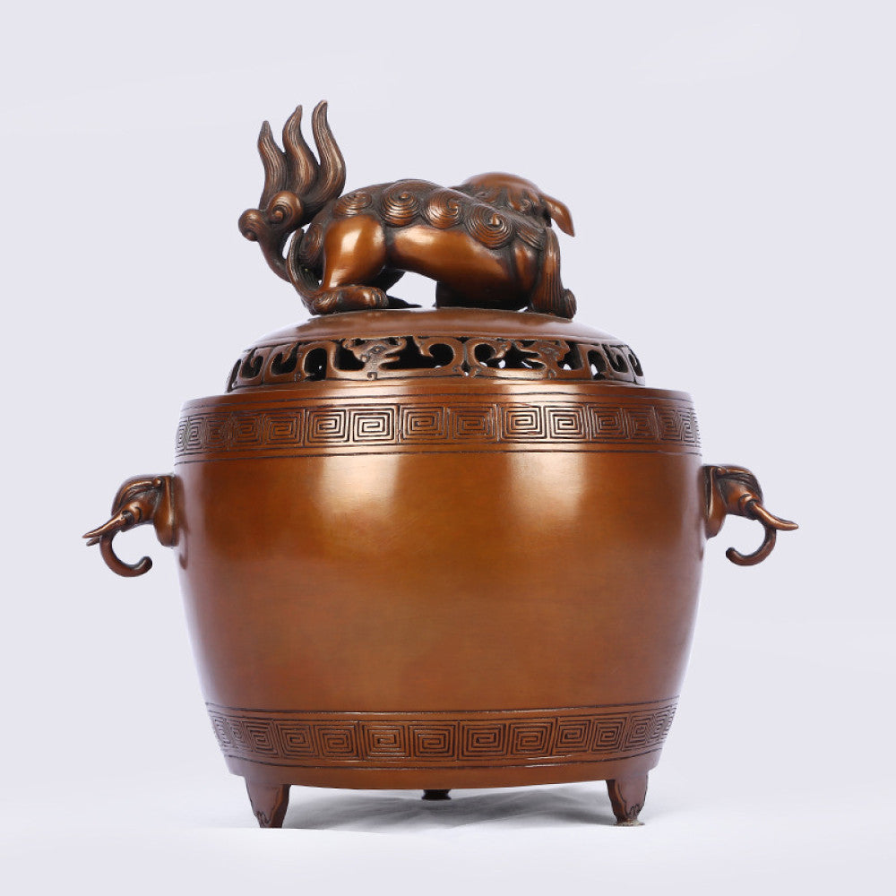 Intricate bronze Chinese incense burner with Foo Dog lid, elephant-head handles, and traditional geometric patterns, a Feng Shui symbol of wealth and protection, displayed as elegant home decor against a white background 05