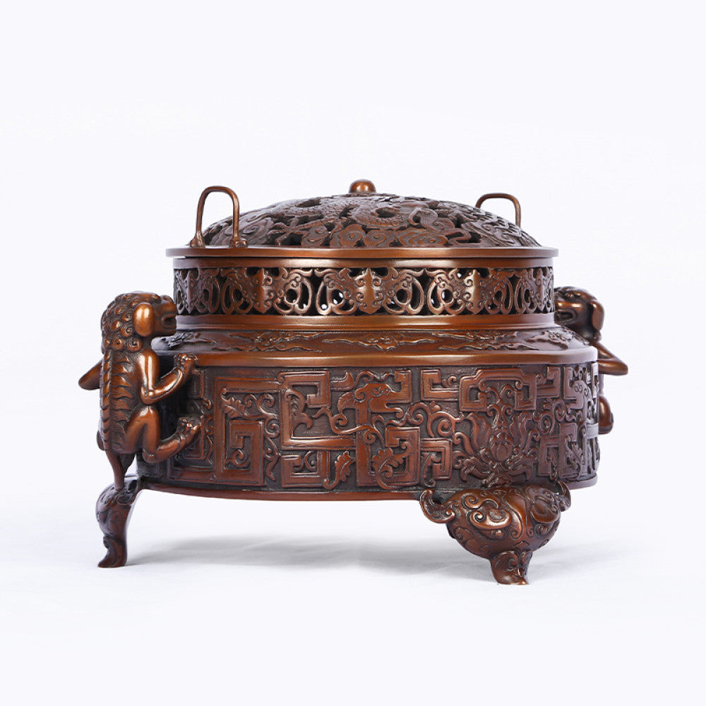 Intricate bronze Chinese incense burner with detailed beast handles, elaborate carvings, and a pierced lid, a Feng Shui symbol of wealth and harmony, displayed as elegant home decor against a white background 01