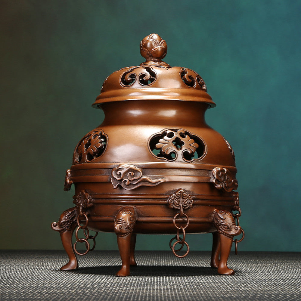 Intricate bronze Chinese incense burner with lotus-topped pierced lid, elaborate cloud carvings, and beast-shaped feet, emitting incense smoke, a Feng Shui symbol of wealth and harmony, displayed as a sophisticated home decor piece against a textured teal background 01