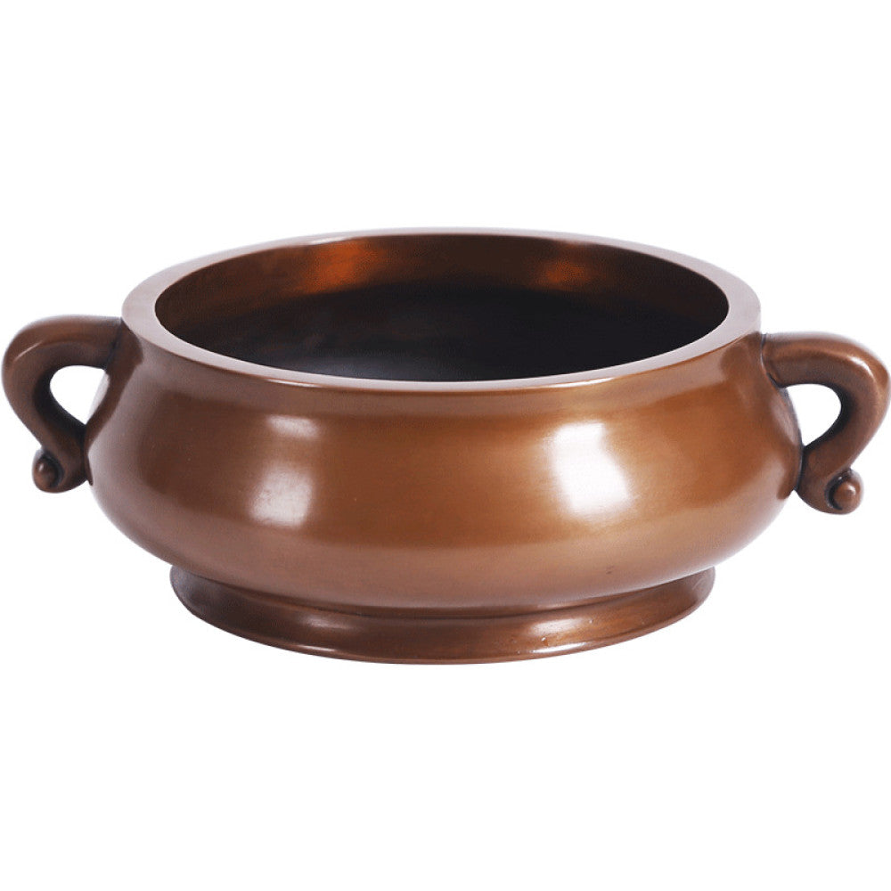 Polished bronze Chinese incense burner with elegant ruyi-shaped handles and a rounded body, a Feng Shui symbol of wealth and harmony, displayed as refined home decor against a dark blue backdrop on a textured surface 06