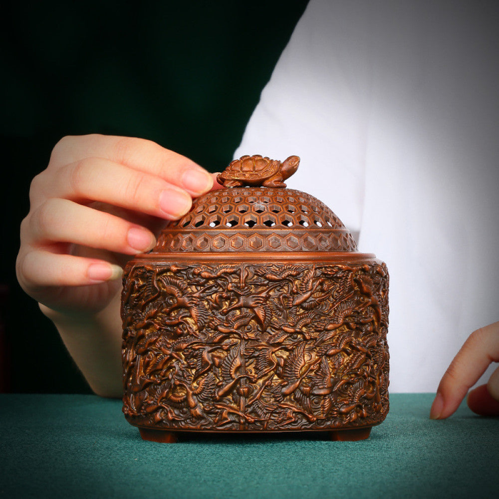 Intricate bronze Chinese incense burner with a tortoise-topped pierced lid and elaborate crane carvings, a Feng Shui symbol of longevity and wealth, displayed as a unique home decor piece against a white background 01