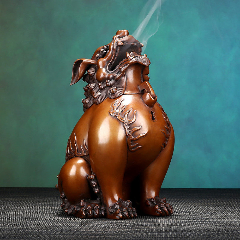 Intricate bronze Foo Dog incense burner with detailed carvings and flame motifs, a Feng Shui symbol of wealth and protection, displayed as elegant home decor against a white background 01