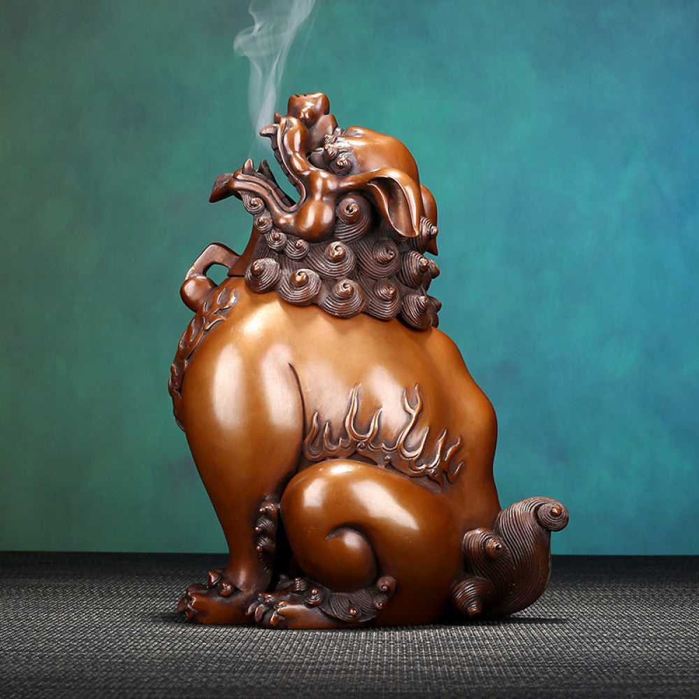Intricate bronze Foo Dog incense burner with detailed carvings and flame motifs, a Feng Shui symbol of wealth and protection, displayed as elegant home decor against a white background 02