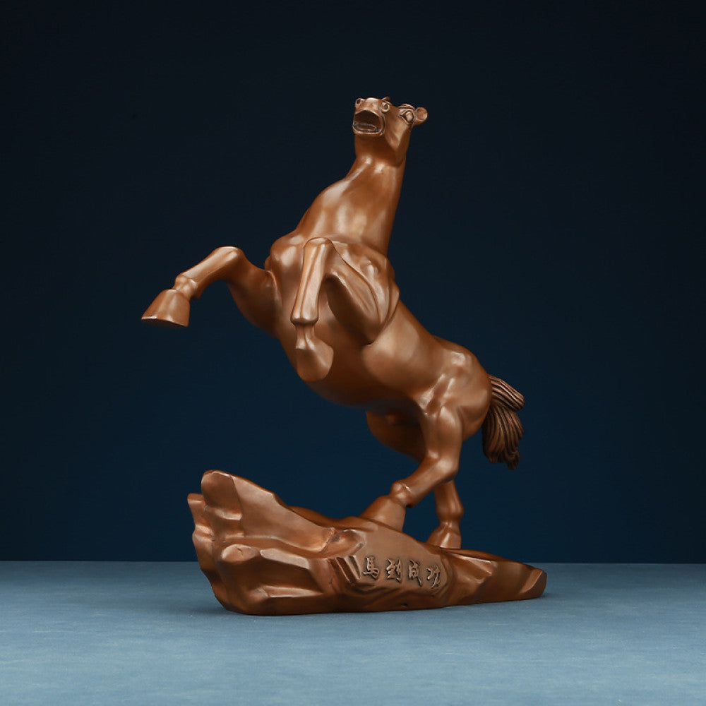 Bronze horse statue with a rearing stance, a Feng Shui symbol of success and achievement, displayed as elegant home decor against a dark blue background 01