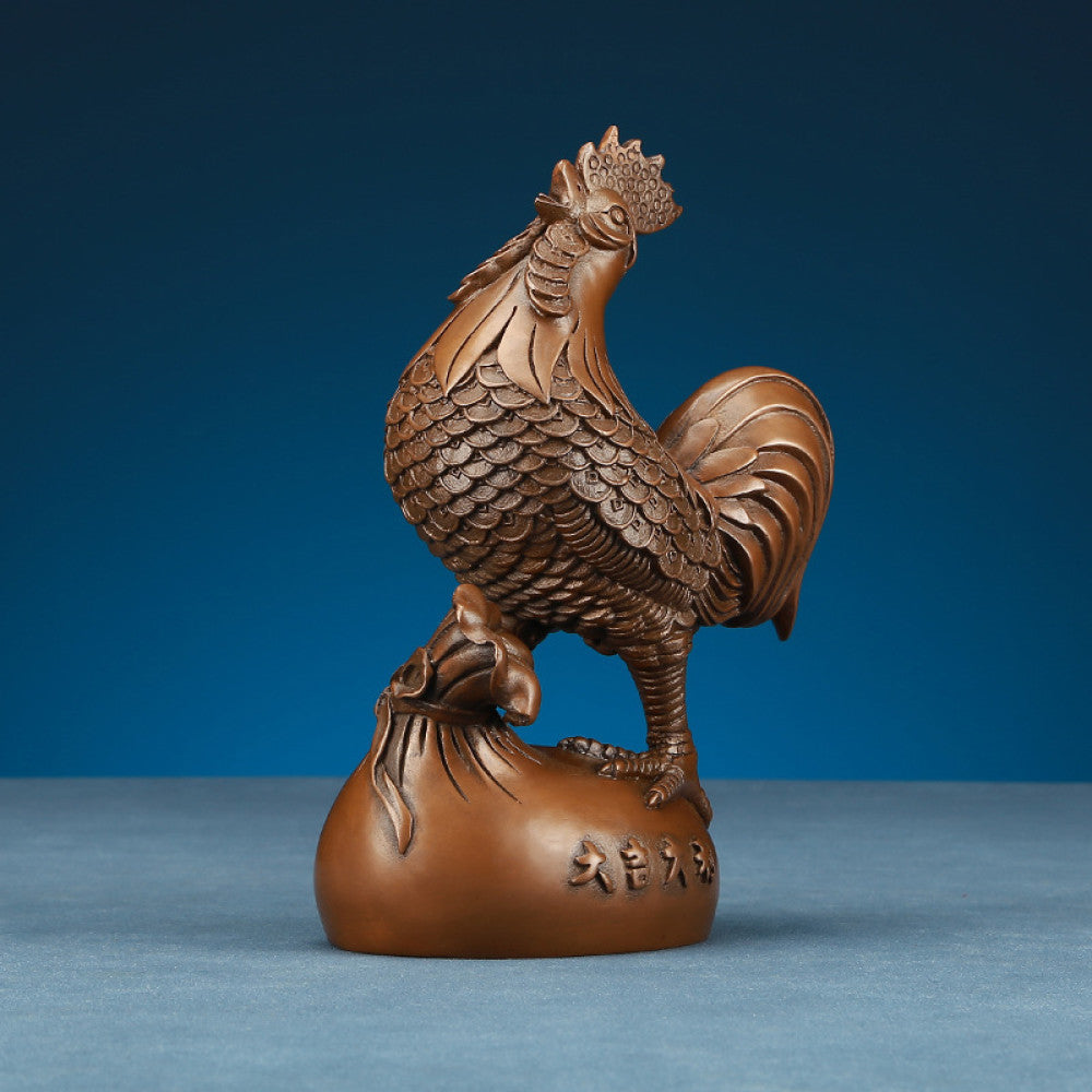 Intricate bronze rooster statue, a Feng Shui symbol of good fortune, displayed as elegant home decor against a blue background