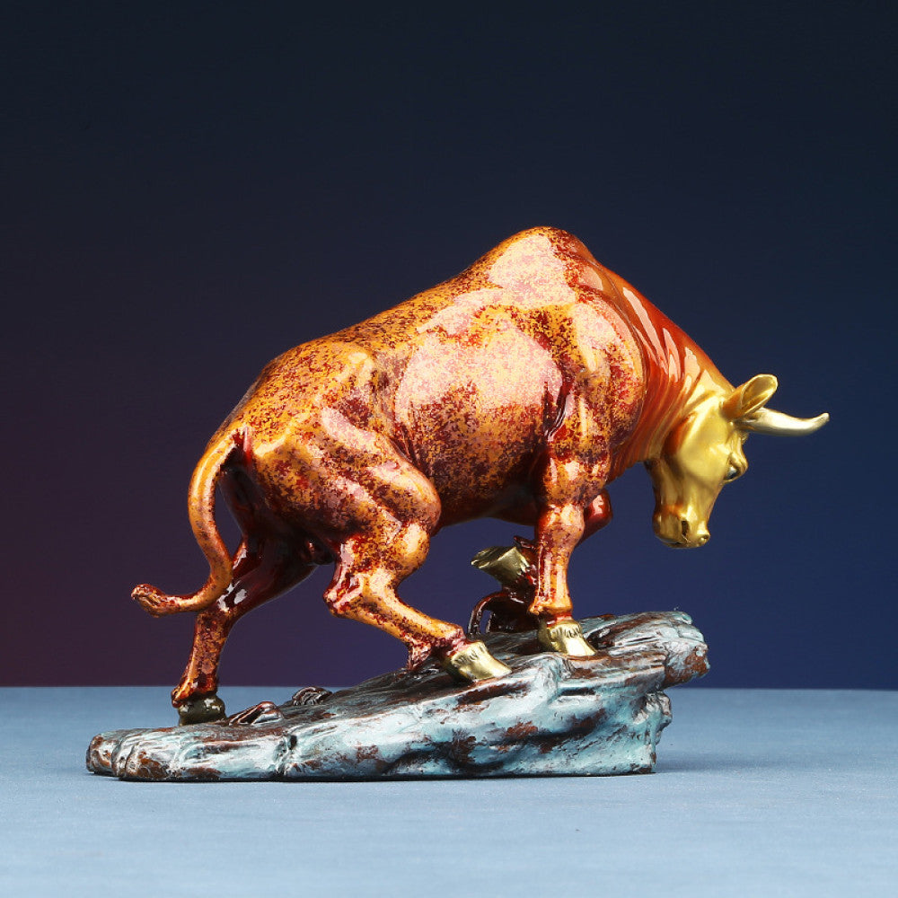 Colorful bull statue with golden accents, a Feng Shui symbol of strength and good fortune, displayed as elegant home decor against a dark background 02