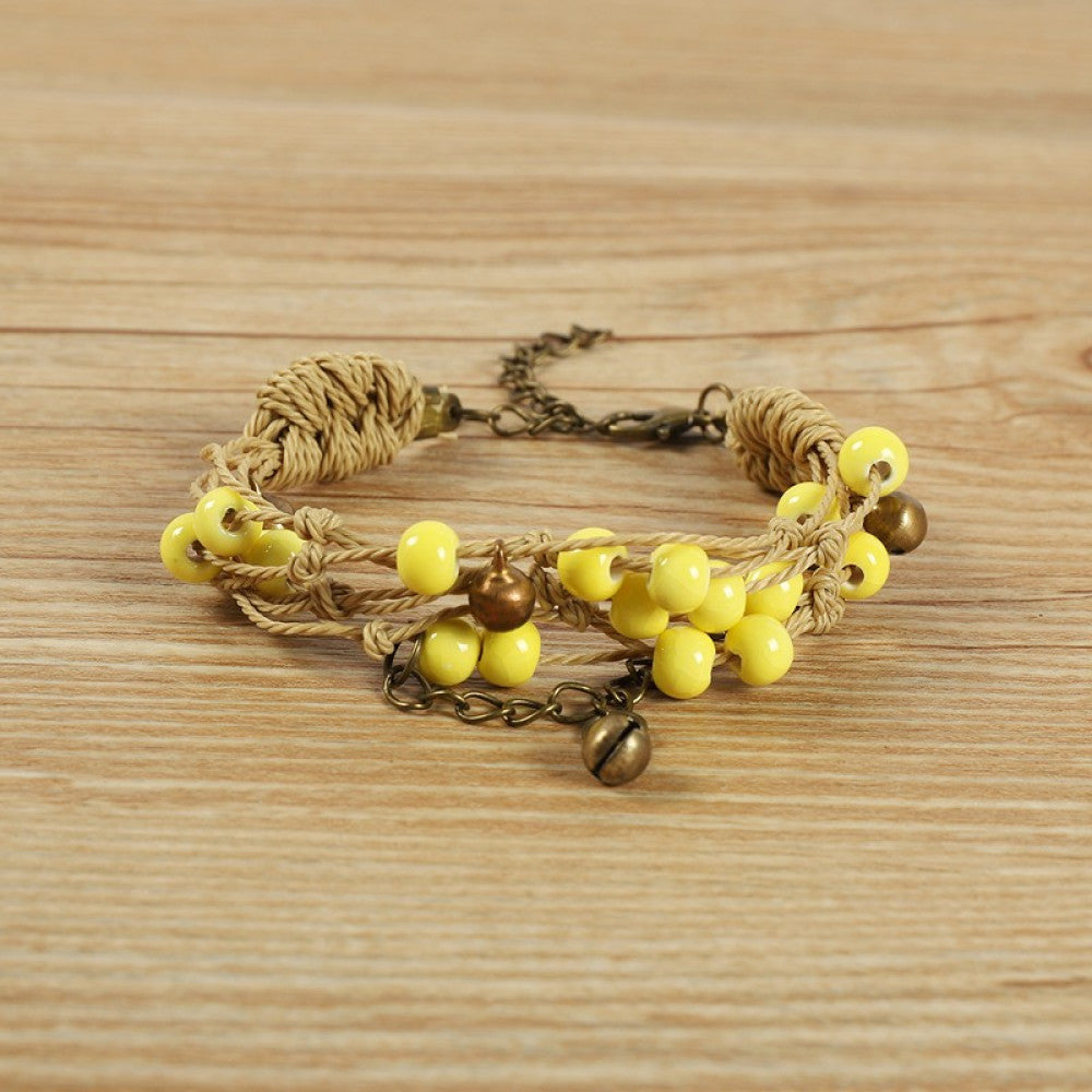 accented with bronze bells and a chain layer. The adjustable clasp ensures a comfortable fit, adding a playful, earthy touch to any outfit.