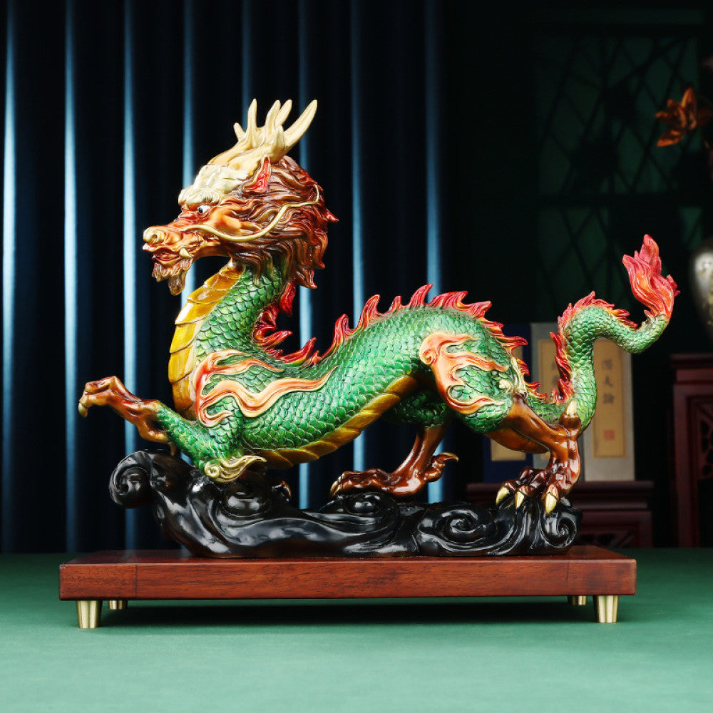 Colorful Chinese dragon statue with green, red, and gold details, a Feng Shui symbol of good fortune and strength, displayed on a wooden base as elegant home decor against a dark background