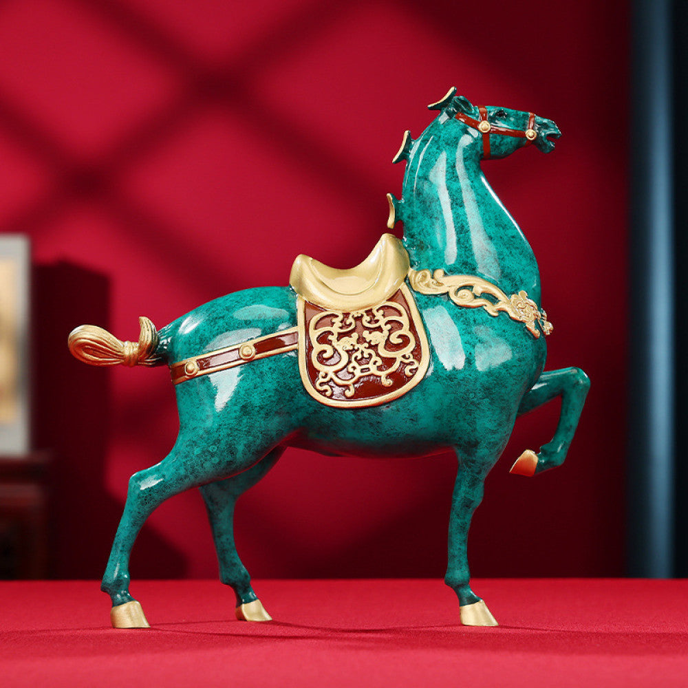 Colorful Chinese - style horse statue with golden accents and intricate patterns, a Feng Shui symbol of good fortune and success, displayed as elegant home decor against a red background