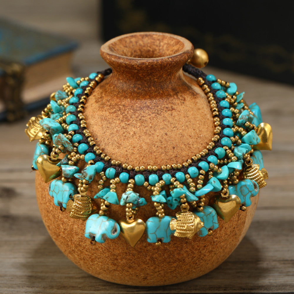 yellow, white, and turquoise, creating a bold ethnic-inspired statement. The intricate design adds a lively