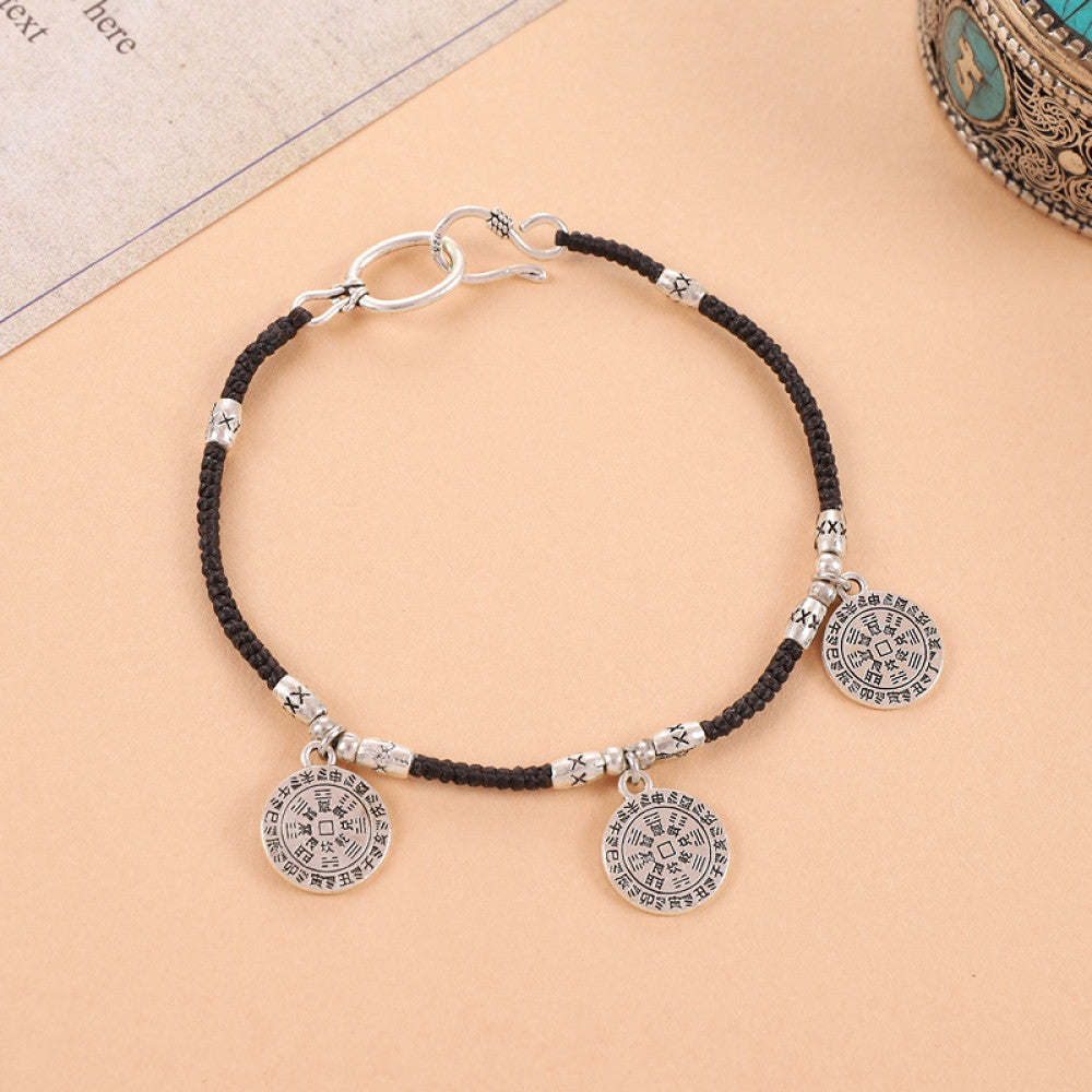 Two silver round tags on black cord, balanced and classic.