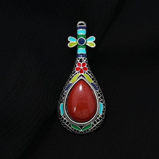 This exquisite brooch features a unique musical instrument-inspired design, crafted with intricate filigree metalwork and vibrant enamel accents. A large, warm amber-hued gemstone takes center stage, surrounded by colorful enamel details that add playful charm. The antiqued silver-tone base enhances its vintage appeal, making it a standout accessory for blazers, scarves, or special occasion outfits, blending artistic craftsmanship with timeless elegance. 0