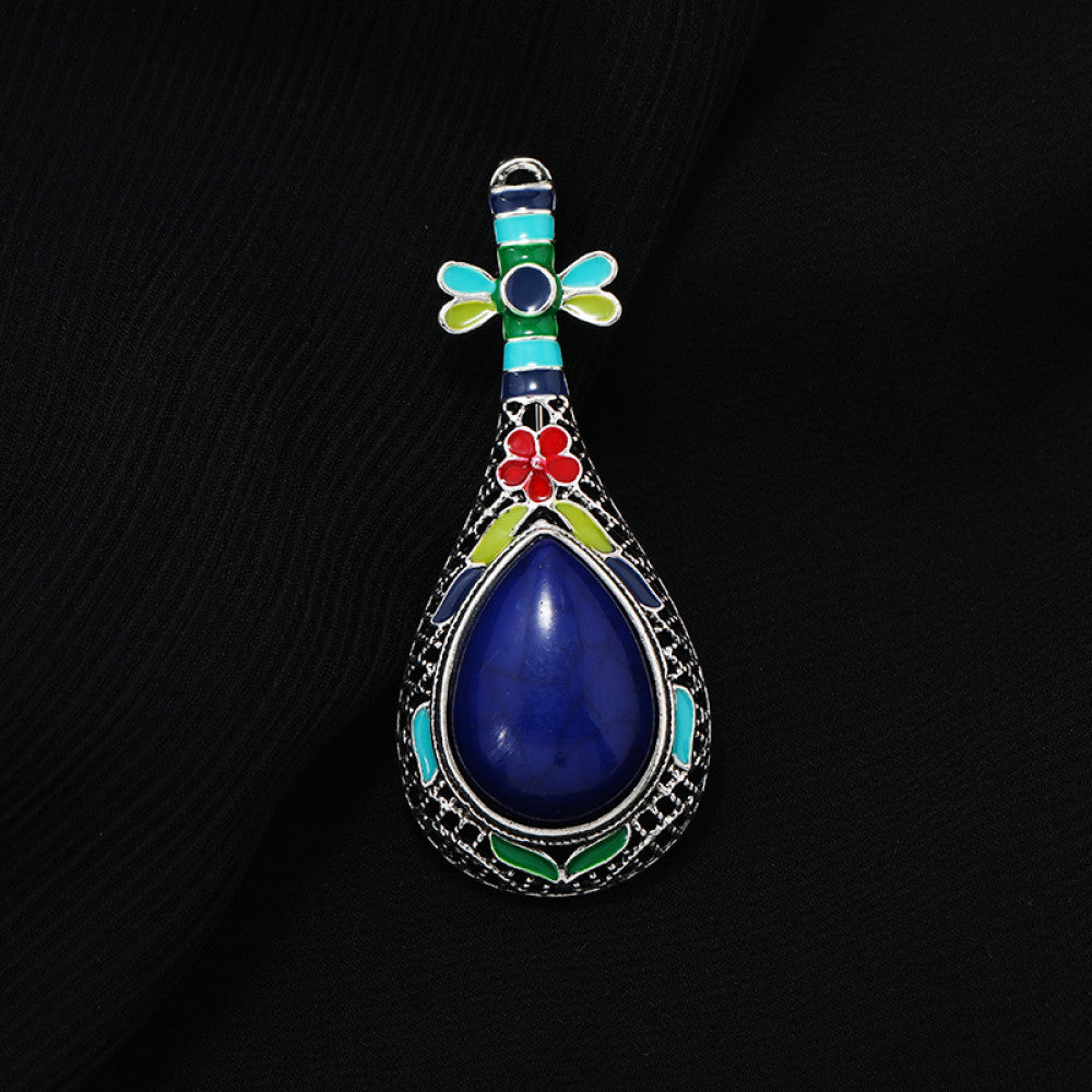 This exquisite brooch features a unique musical instrument-inspired design, crafted with intricate filigree metalwork and vibrant enamel accents. A large, warm amber-hued gemstone takes center stage, surrounded by colorful enamel details that add playful charm. The antiqued silver-tone base enhances its vintage appeal, making it a standout accessory for blazers, scarves, or special occasion outfits, blending artistic craftsmanship with timeless elegance. 03