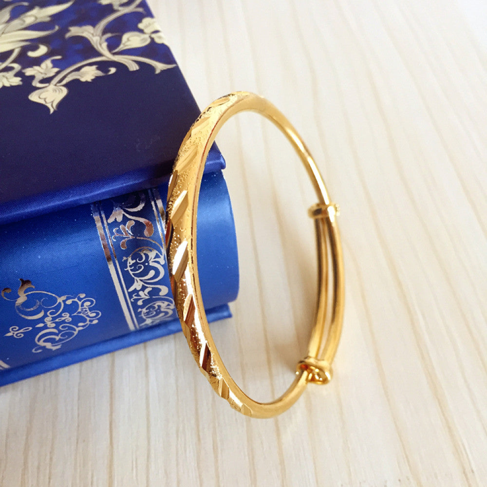 Fashion luxury engraved gold bangle, styled on a decorative black surface, ideal for elegant fashion enthusiasts in the US 03