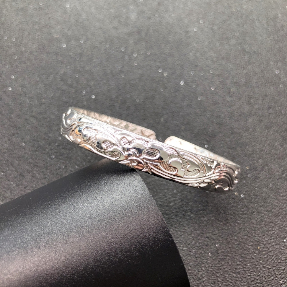 Fashion luxury love-inspired silver cuff bangle, styled on a sleek surface, ideal for elegant and trendy fashion enthusiasts in the US 04