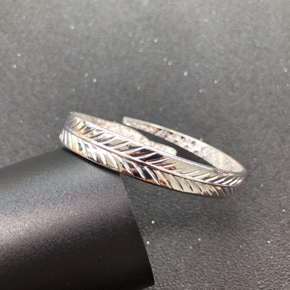 Fashion luxury love-inspired silver cuff bangle, styled on a sleek surface, ideal for elegant and trendy fashion enthusiasts in the US 07