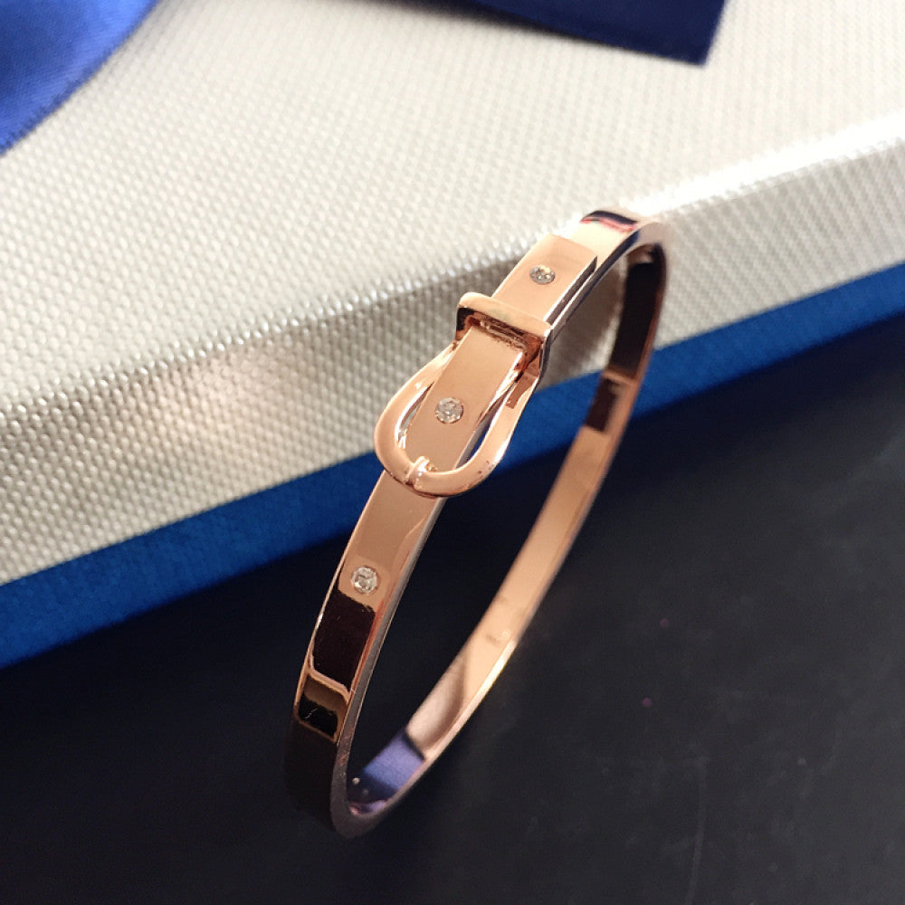 Fashion luxury rose gold bangle with diamond-encrusted buckle, styled with a gift box, ideal for elegant fashion enthusiasts in the US