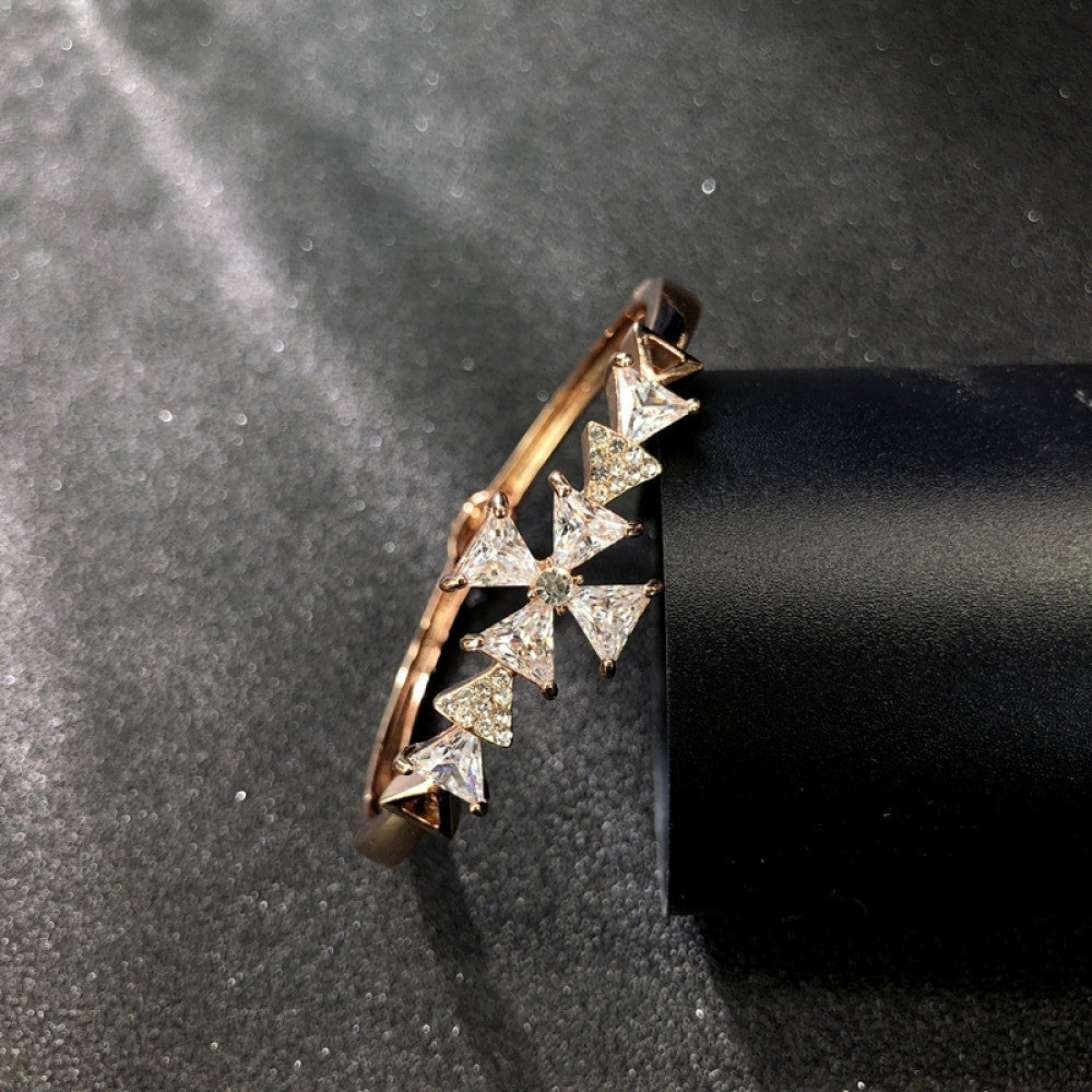 Fashion luxury rose gold bangle with heart-shaped diamond and intricate designs, displayed on black surface, ideal for luxury fashion and special occasion enthusiasts 6