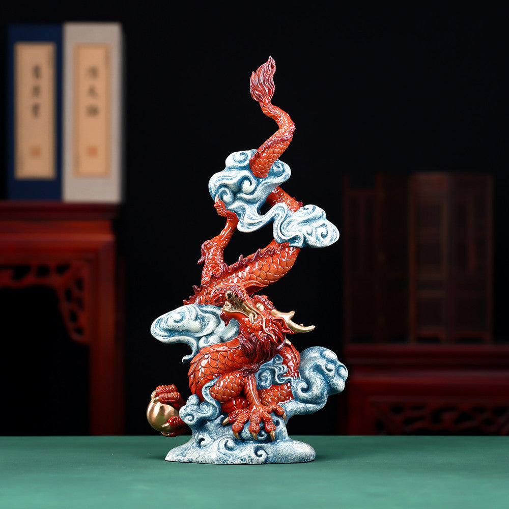Intricate red Chinese dragon statue with gold accents, coiled around clouds and holding a treasure, a Feng Shui symbol of good luck and strength, displayed against a dark blue background 01