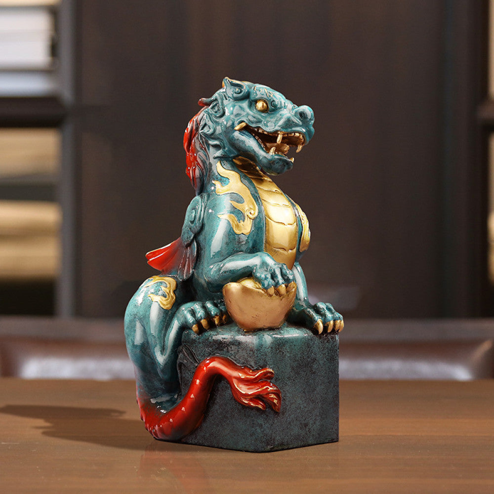 Intricate teal and gold Chinese dragon statue, a symbol of power and good fortune in feng shui, placed on a square base against a warm-toned background