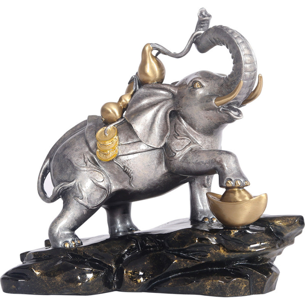 Feng Shui elephant statue with gourd and golden ingot, a symbol of prosperity and good luck, positioned on a rocky base against a white background